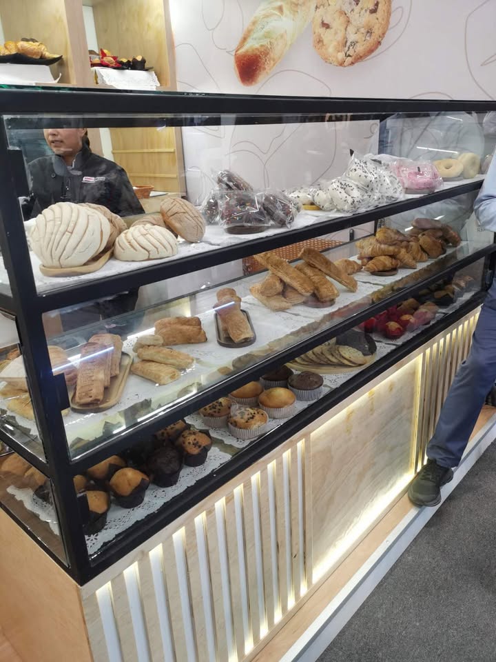 Bakery display case with pan dulce and muffins at ABASTUR 2026